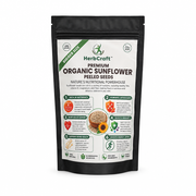 HerbCraft Premium Organic Sunflower Peeled Seeds 100g pouch ka front view, sunflower seeds ki illustration aur product name ke saath, black background par, docxora.com Pakistan.