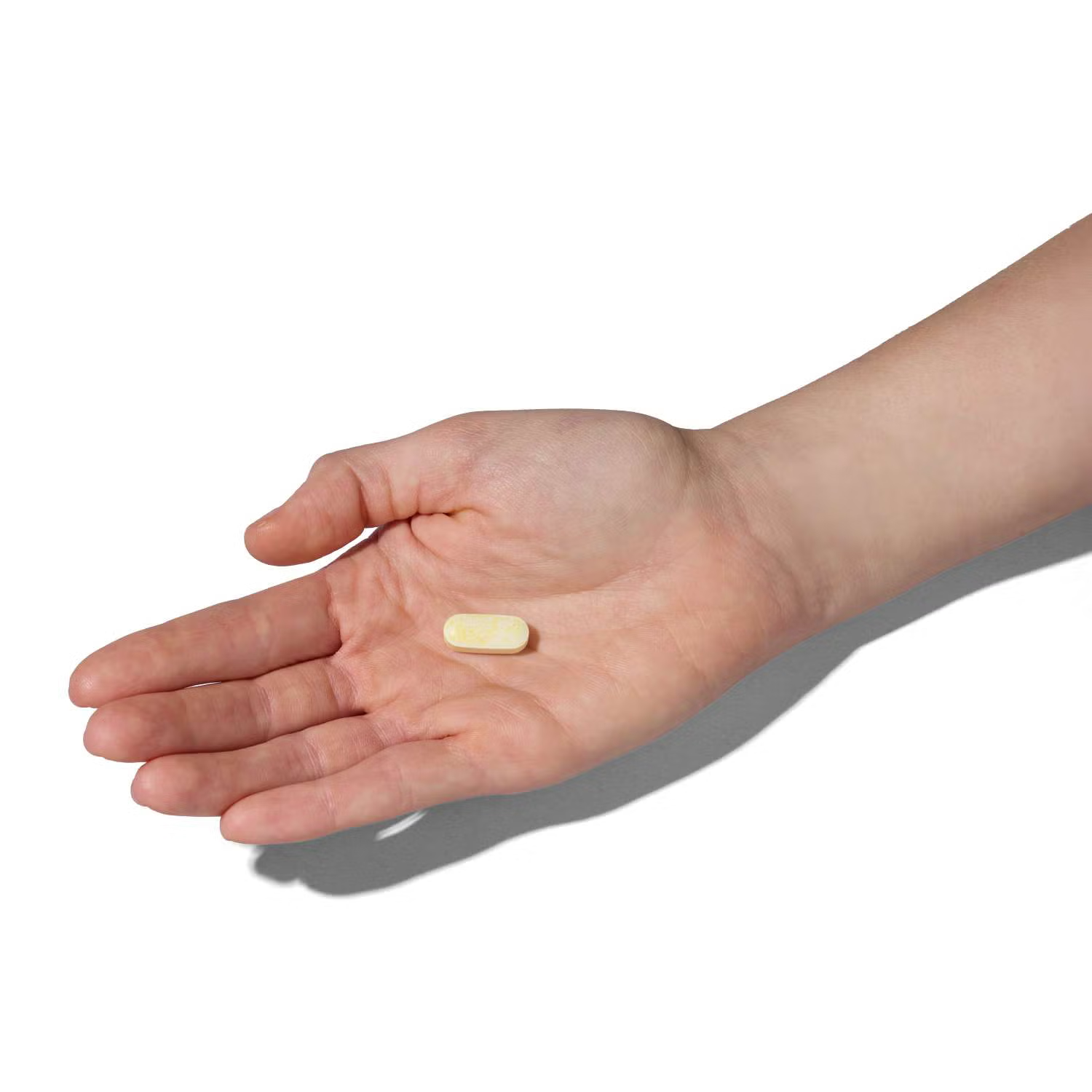 GNC Alpha-Lipoic Acid 600mg Caplet Size Reference - small cream-colored oval caplet shown in hand for actual size comparison